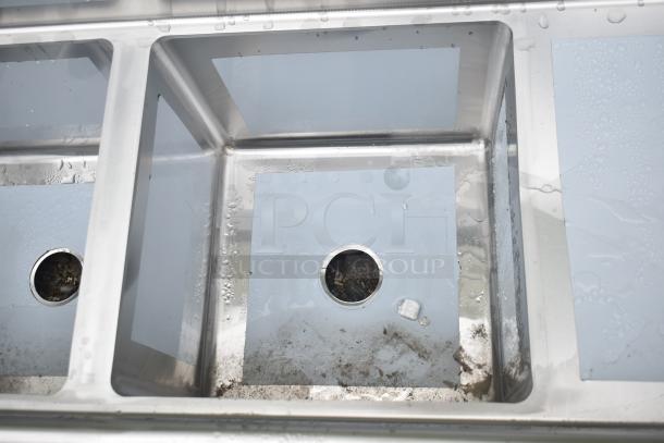 Regency 600S31818218 stainless steel three compartment sink, 94", with cross bracing and 2 drainboards. Scratched and dented.