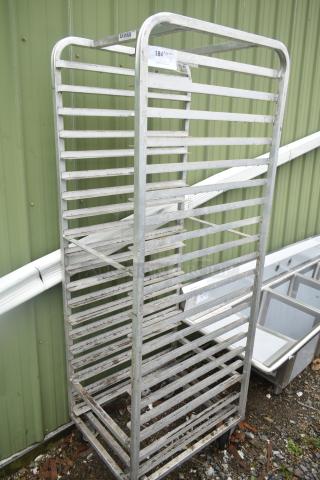 Commercial pan transport rack with multiple shelves on sturdy commercial casters, metal construction, used condition.