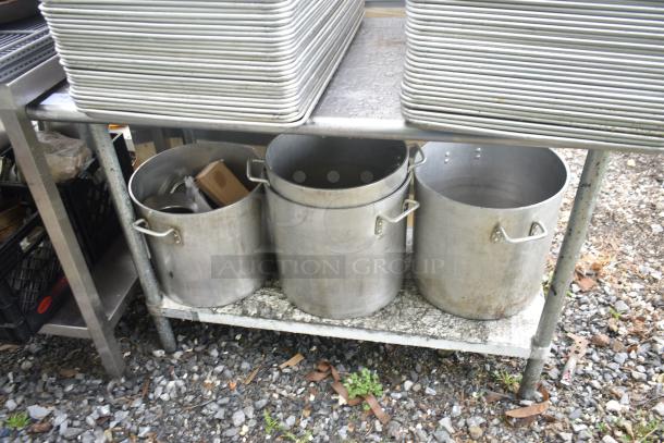 Commercial table with four aluminum stock pots, used condition, two-tier design, metal construction, ideal for kitchen use.