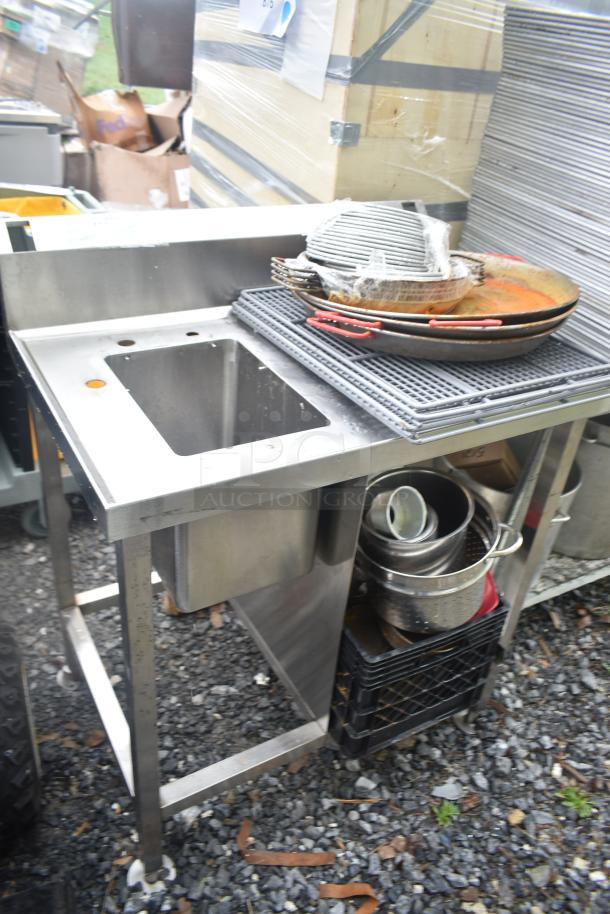 Single stainless steel bay sink with various skillets on top, includes cookware in lower storage. Used condition.