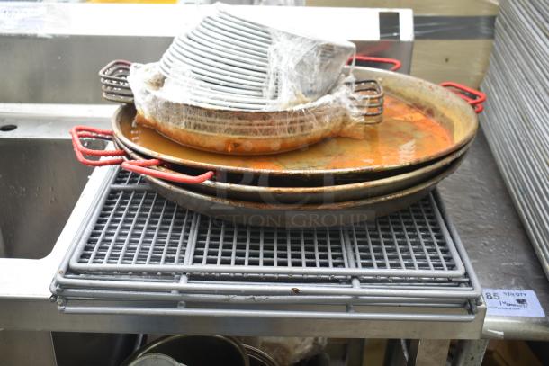 Single bay sink with stacked skillets, some rust present, red handles, metal grates, auction tag visible.
