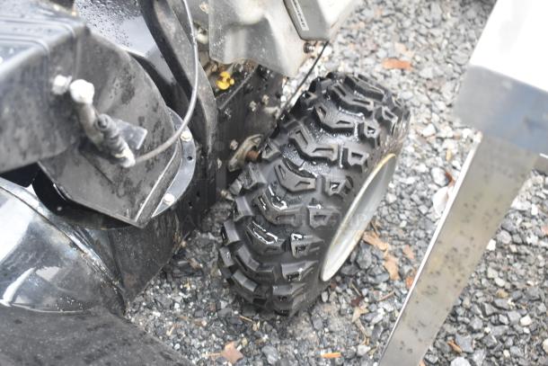 Briggs & Stratton Murray 1695720 Snow Thrower, rugged tire detail, used condition, visible mechanical components.