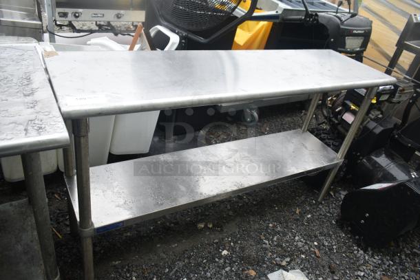 Commercial stainless steel table with under shelf, used condition, sturdy design, suitable for kitchen or workshop use.