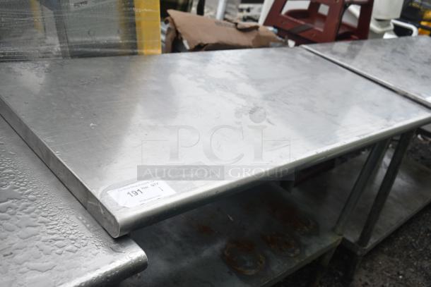 Stainless steel commercial table with under shelf, visible wear, auction tag indicating lot 191.