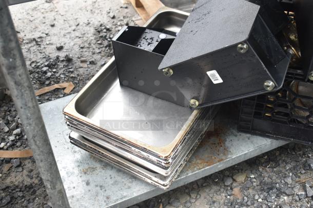 Commercial table with under shelf, featuring multiple drop-in bins, stock pots, and metal pans. Slight rust visible.