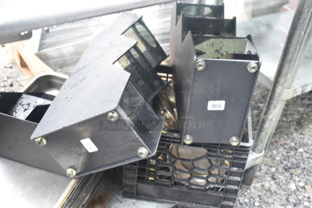 Commercial table with under shelf, drop-in bins, and stock pots. Metal surface with removable black panels. Used condition.