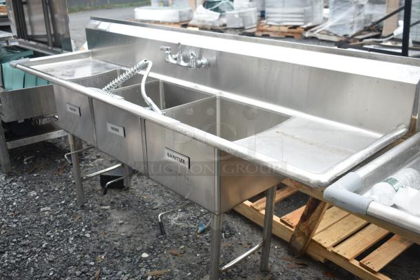 Commercial 3 Bay Sink with dual drain boards, labeled for wash, rinse, sanitize; stainless steel; pre-owned condition.
