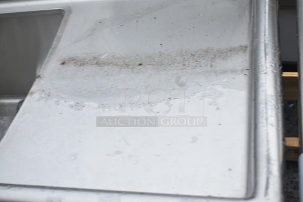 Commercial 3 Bay Sink with Dual Drain Boards, stainless steel, visible wear and dirt marks, ideal for heavy-duty use.