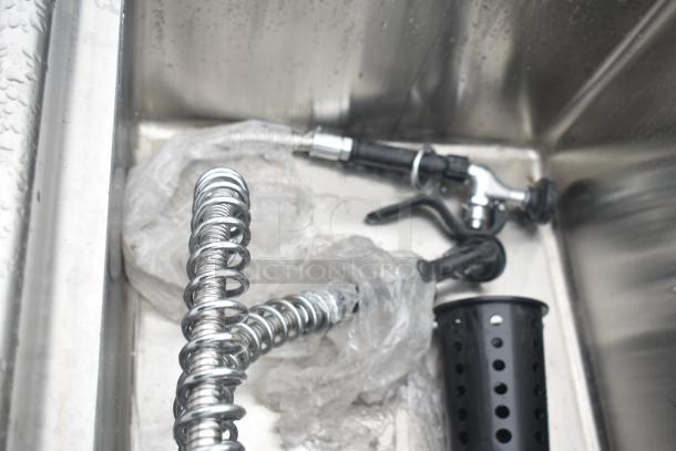 Commercial 3 Bay Sink with dual drain boards, stainless steel, chrome fixtures, protective wrapping, clean condition.