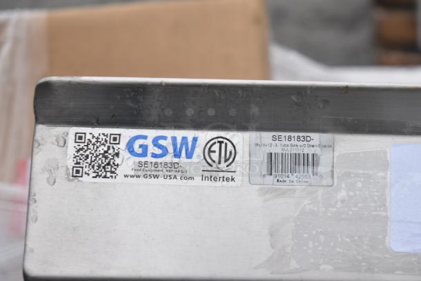 Label on a GSW commercial 3 bay sink with dual drain boards, model SE18183D. Features NSF certification by Intertek.