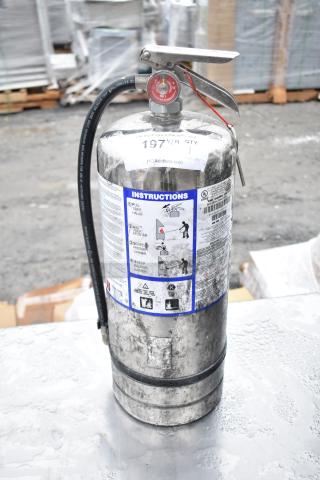 Metal fire extinguisher with visible handling instructions and pressure gauge; buyer must pick up.