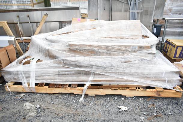 Eight brand new scratch and dent items wrapped on a pallet, including item K03000819PKG. Bulk purchase opportunity.