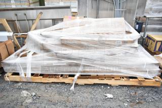 Eight brand new scratch and dent items wrapped on a pallet, including item K03000819PKG. Bulk purchase opportunity.