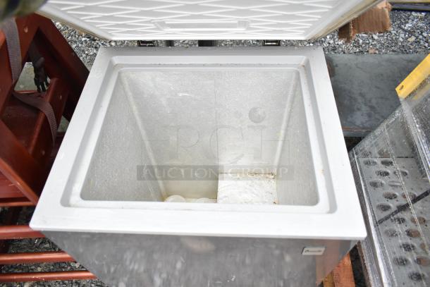 Chest freezer with lid open, showing interior. 115 volts, 1 phase. Slight wear visible inside. No visible brand label.