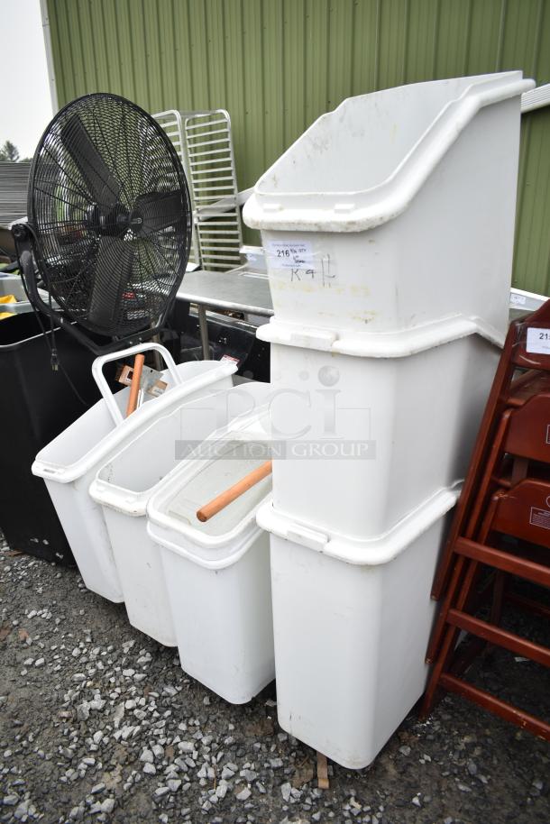 Six white poly ingredient bins with lids and wooden handles. Signs of light wear. Auction label reads "216."