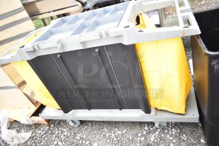 Lavex Janitorial Cart with commercial casters, featuring a black frame, yellow bag, and multiple compartments, in good condition.