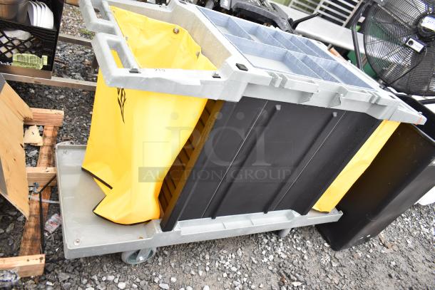 Lavex janitorial cart, gray with yellow vinyl bag and black compartments, mounted on commercial casters. Good condition.