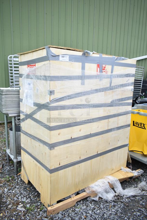 Wooden crate with protective wrapping and tape, labeled "220V" and "Handle with Care." Crate condition appears intact.