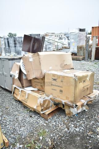 Damaged boxes labeled Regency, containing new scratch and dent items like a pot rack and mop sink, on gravel lot.
