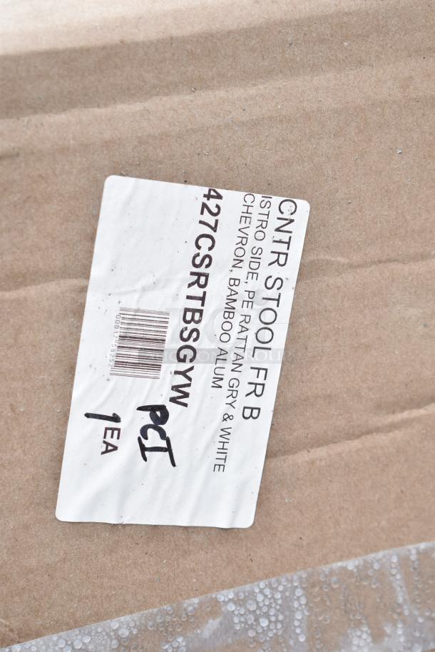 Label on package indicating "CNTR STOOL FRB," featuring PE rattan in grey and white chevron design. Item new, 1 each.