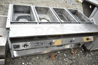 ServeWell Commercial 4 Bay Steam Table in used condition, stainless steel with visible wear. Model tag on front panel.