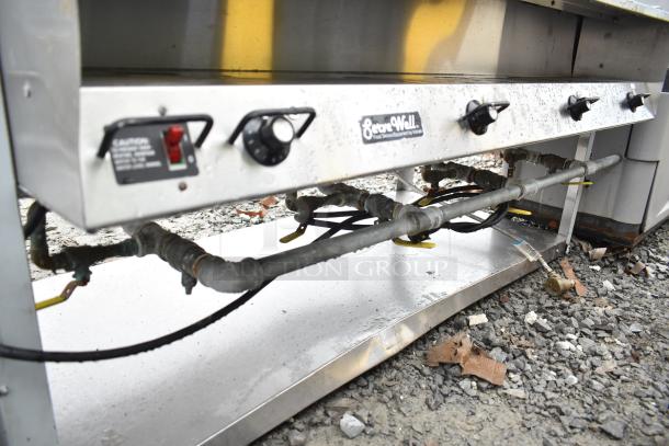 ServeWell Commercial 4 Bay Steam Table with control knobs. Visible wear and outdoor placement on gravel surface.