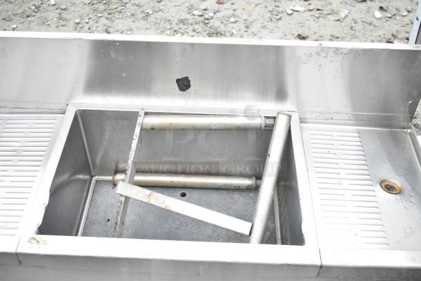 Commercial 3 Bay Back Bar Sink with ice bin and speedwell, stainless steel construction, visible wear, durable for bar use.