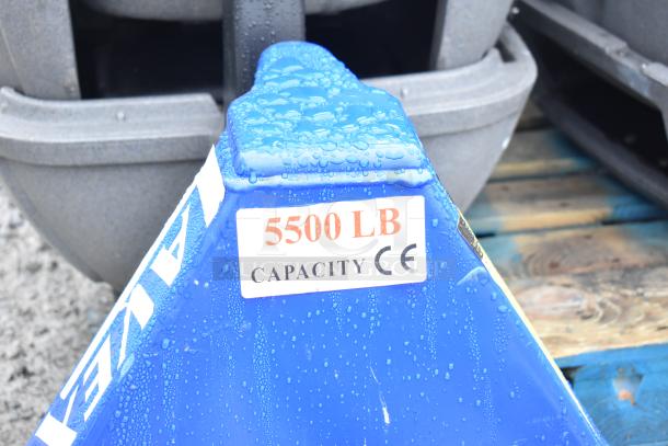 Lavex Commercial pallet jack, blue, 5,500 lb capacity, CE marked, wet with water droplets, resting on a wooden pallet.