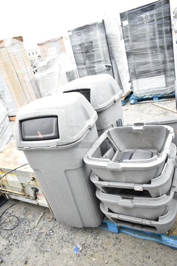 Two gray poly trash cans with lids, showing slight wear. Includes seven additional lids stacked beside them.