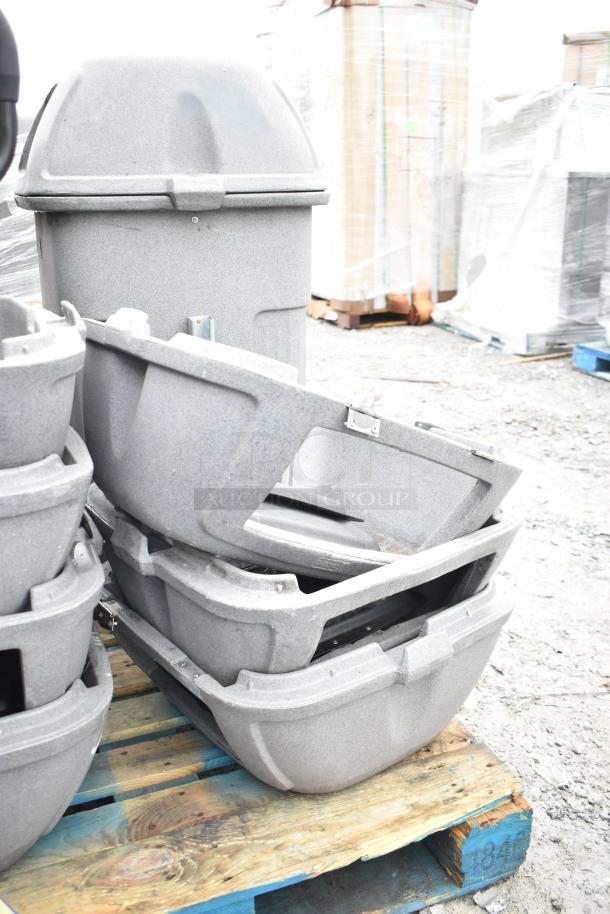 2 gray poly trash cans and 7 lids on a pallet, suitable for outdoor use, sturdy construction, good condition.