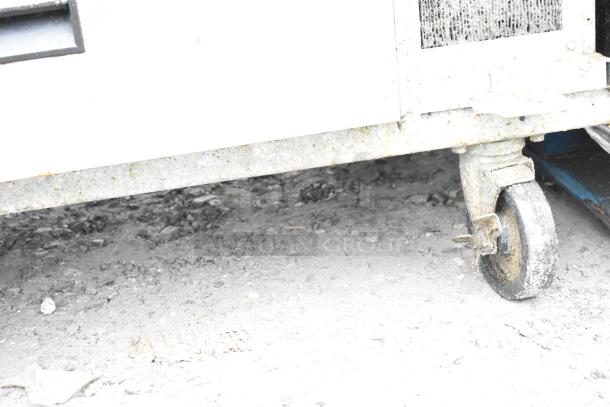 Delfield 2 Drawer Chef Base on commercial casters, visible wear, 115V, 1 Phase. Features mobility for kitchen use.