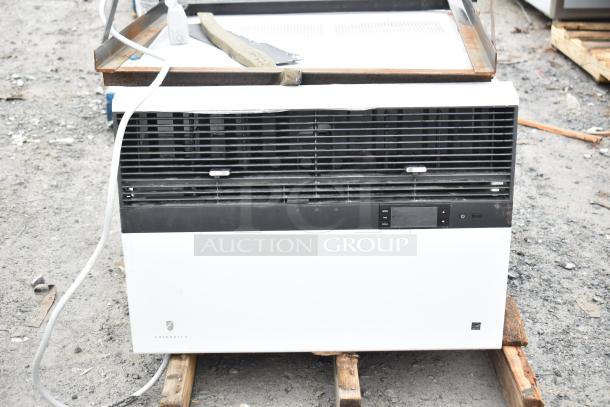 Friedrich air conditioner, 120/208 volts, 1 phase, used condition. Black and white design, visible control panel.