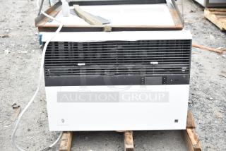 Friedrich air conditioner, 120/208 volts, 1 phase, used condition. Black and white design, visible control panel.