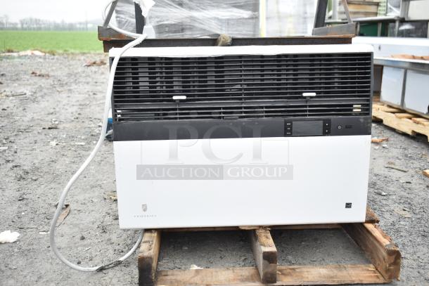 Friedrich Air Conditioner, 120/208V, 1 phase, mounted on pallet. Black and white design, controls visible. Used condition.