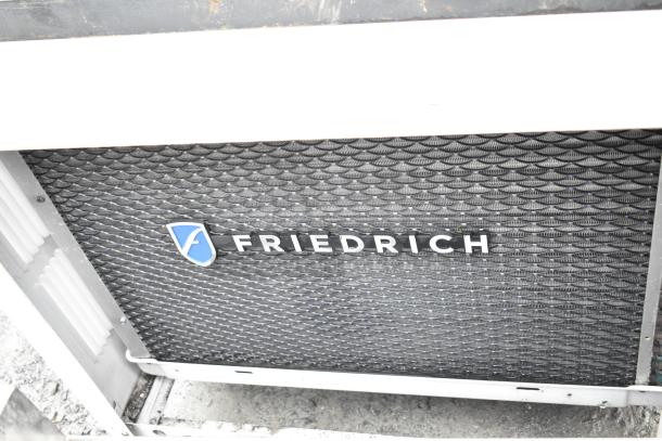 Friedrich air conditioner, 120/208 volts, 1 phase, black grille with Friedrich logo, in good condition.
