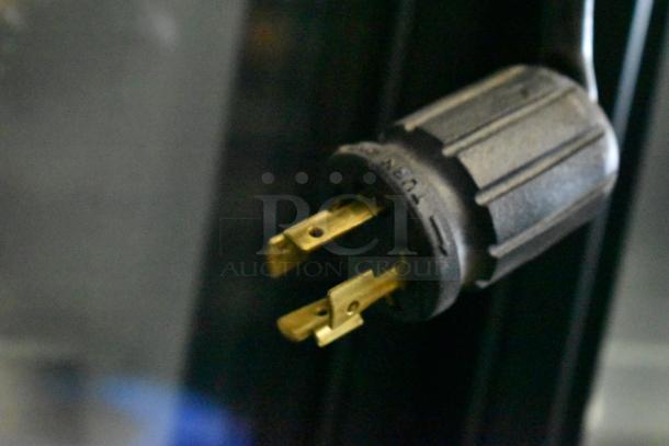 Close-up of the power plug for a 2018 True GDM-72F-HC commercial 3-door freezer merchandiser.