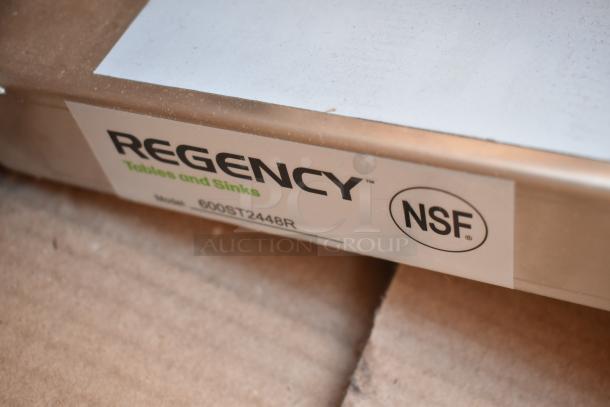 BRAND NEW Regency 600ST2448R stainless steel work table with sink, 24"x48", 16 gauge. Scratch and dent condition, NSF label visible.