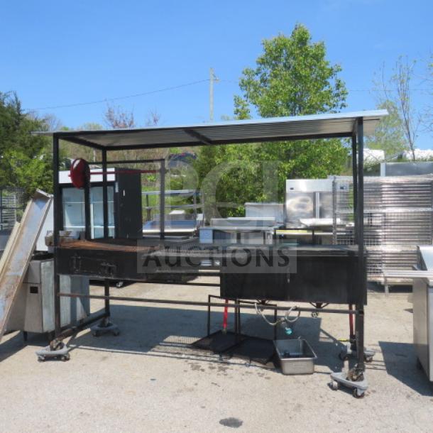 Outdoor cooking appliance with grill, dual deep fryer, covered roof, and casters. Dimensions: 109x34x83 inches.