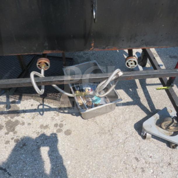 One unique outdoor BBQ and frying appliance with grill area, dual deep fryer, covered roof, on casters, measures 109x34x83.