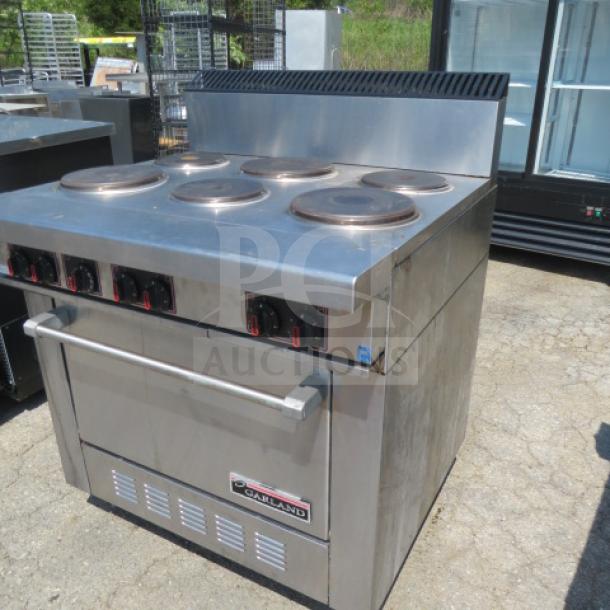 Garland natural gas 6 burner range, stainless steel, features control knobs and oven below, good condition.
