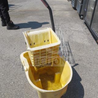 Rubbermaid yellow mop bucket with wringer, used condition, sturdy handle, visible water residue.