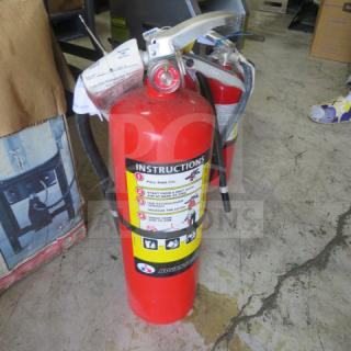 Badger ABC fire extinguisher, red, includes instructions label. Silver nozzle, black hose. Good condition.