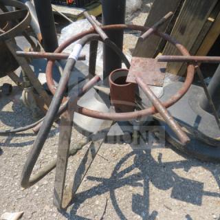 Rustic single gas burner with metal frame, showing wear and patina. Lacks visible branding or model info.