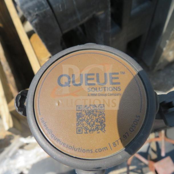 Queue Solutions crowd control pole, top view. Features logo, QR code, company contact info, good condition.