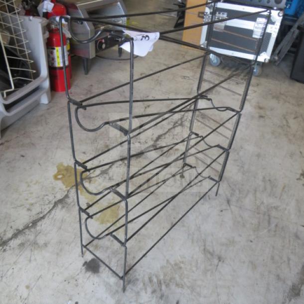 Wire cup organizer with multiple tiers in used condition, suitable for kitchen or office storage.