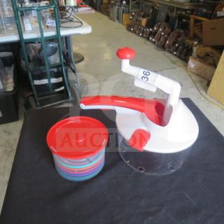 Manual chopper/slicer with red and white handles and clear base, includes matching red-lid container. Item tagged number 36.