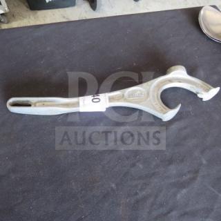 Metal bucket opener with ergonomic handle, embossed "Hales," in good condition, resting on a black surface.