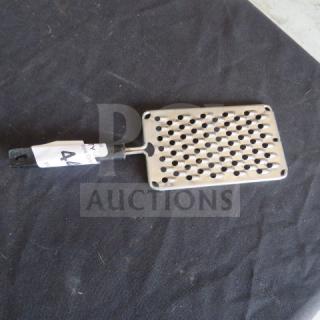 Metal hand grater with a black handle. Features large holes for grating, visible auction tag with number 44.
