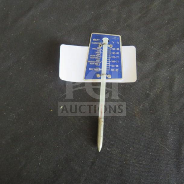 Metal meat thermometer with blue temperature guide, showing cooking levels for various meats. Good condition.