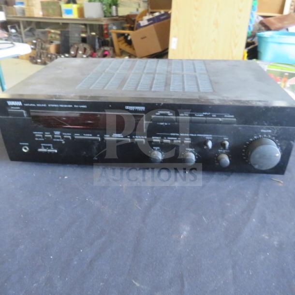 Yamaha stereo receiver, model RX-460, black finish, various control knobs, used condition with visible wear.